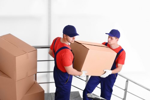 Removal team planning a move in a Stockwell flat with stairs and boxed items