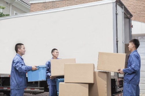 Movers handling a residential move in Stockwell with packed boxes and furniture