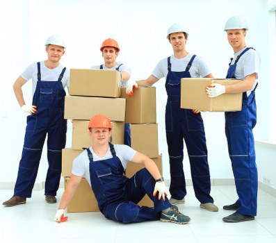 Packed office furniture and boxes ready for a business move in Stockwell