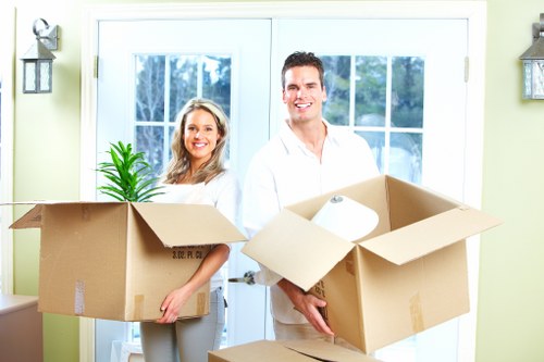 Local movers handling furniture in a Stockwell property with narrow access